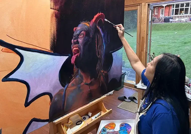 Marissa working on the painting of Steffano Marcano